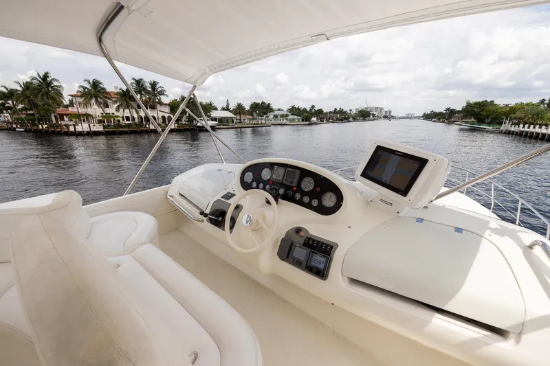 Slide: The Image of Cockpit view of 1999 Azimut 58 yacht navigating a scenic waterway. - 41