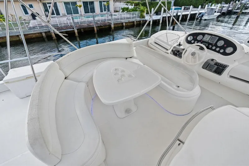 Slide: The Image of Luxurious 1999 Azimut 58 yacht interior with white seating and control panel. - 45