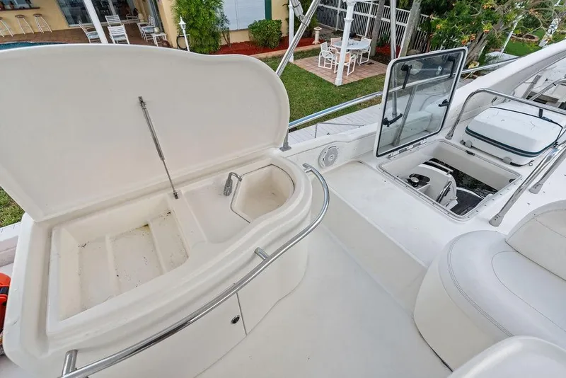 Slide: The Image of Open storage compartments on a 1999 Azimut 58 yacht deck, showcasing seating and amenities. - 47