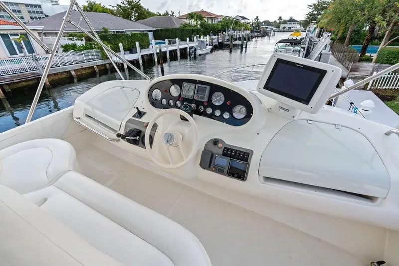 Slide: The Image of Cockpit of 1999 Azimut 58 yacht with steering wheel and navigation equipment. - 48