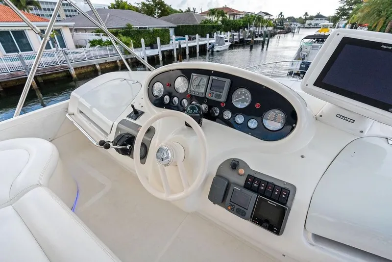 Slide: The Image of Cockpit of a 1999 Azimut 58 yacht with steering wheel and navigation instruments. - 50