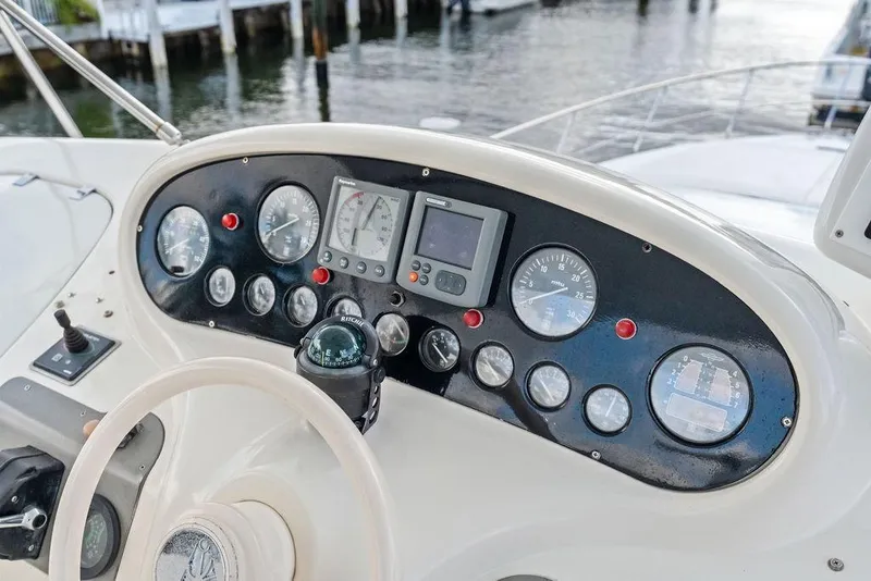Slide: The Image of Control panel of a 1999 Azimut 58 yacht with gauges and navigation instruments. - 51