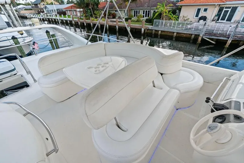 Slide: The Image of Luxurious seating area on a 1999 Azimut 58 yacht, docked by waterfront homes. - 52
