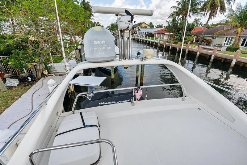 Slide: The Image of 1999 Azimut 58 yacht deck with satellite equipment, docked by waterfront homes. - 54