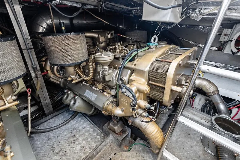 Slide: The Image of Engine room of a 1999 Azimut 58 yacht, showcasing detailed machinery and components. - 55