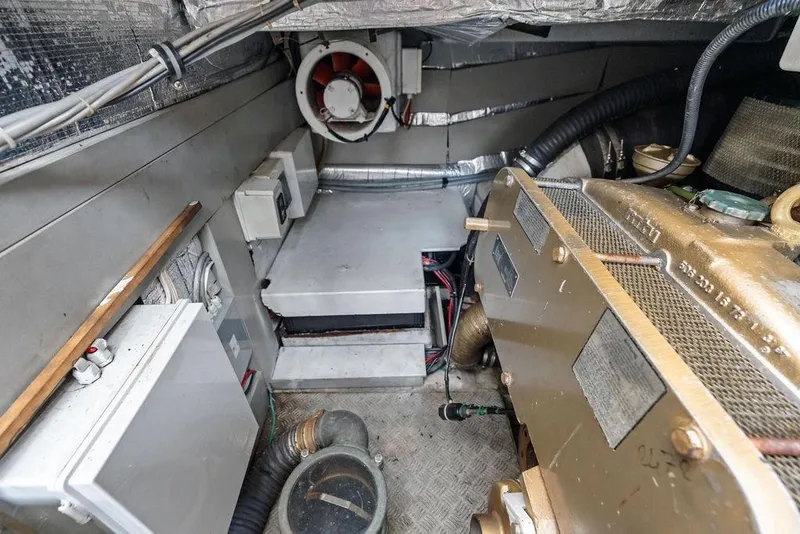Slide: The Image of Engine room of a 1999 Azimut 58 yacht, showcasing machinery and ventilation systems. - 57