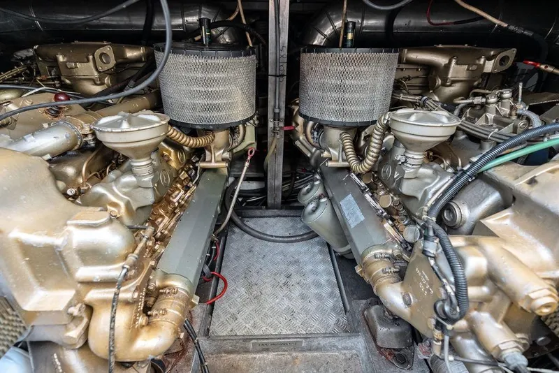 Slide: The Image of Engine room of a 1999 Azimut 58 yacht, showcasing dual engines and components. - 59