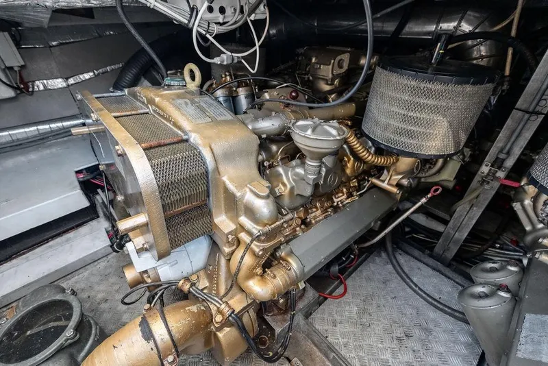 Slide: The Image of Engine room of a 1999 Azimut 58 yacht, showcasing detailed machinery components. - 60
