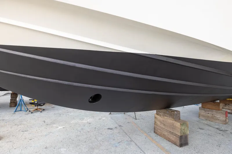 Slide: The Image of Bottom view of a 1999 Azimut 58 yacht hull on dry dock. - 62