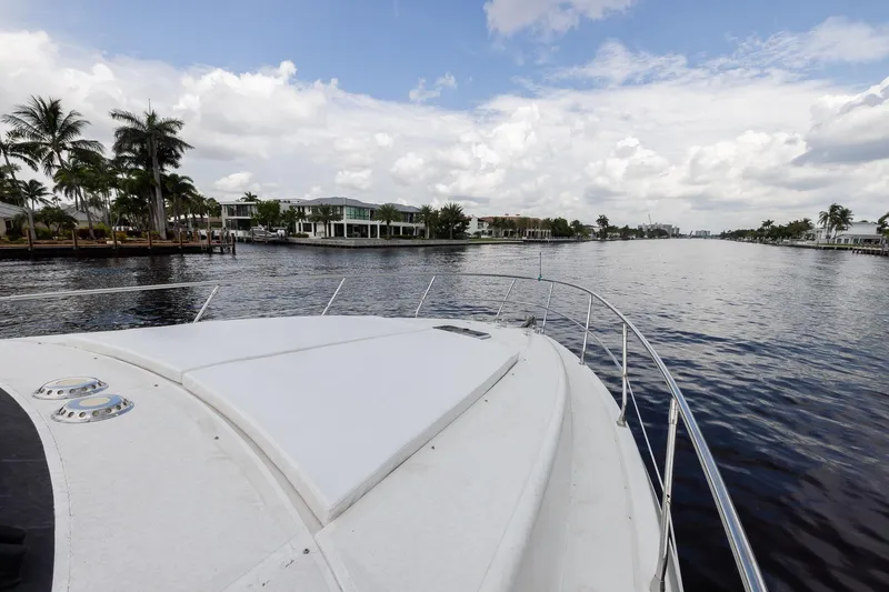 Slide: The Image of Bow view of 1999 Azimut 58 yacht cruising on a scenic waterway. - 8