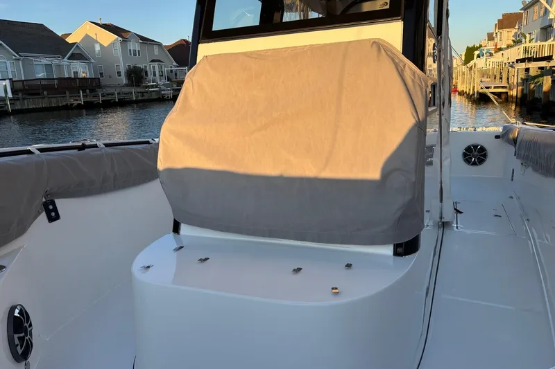 Slide: The Image of 2021 Sea Pro 320 DLX Center Console boat docked near waterfront homes. - 12