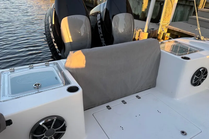 Slide: The Image of 2021 Sea Pro 320 DLX Center Console boat with dual Suzuki engines at dock. - 13