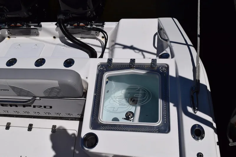 Slide: The Image of 2021 Sea Pro 320 DLX Center Console boat interior with seating and storage features. - 17