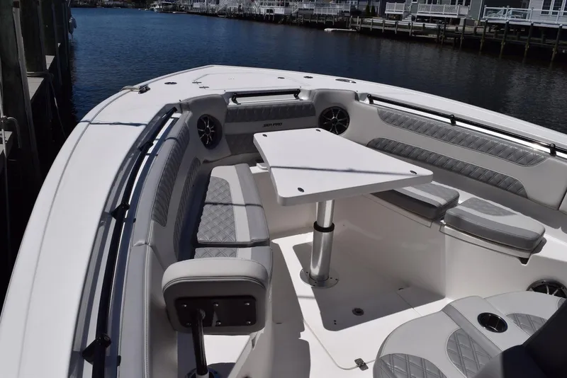 Slide: The Image of 2021 Sea Pro 320 DLX Center Console boat with spacious seating and table setup. - 21