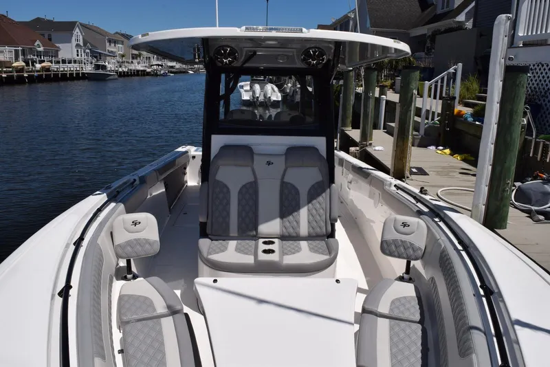 Slide: The Image of 2021 Sea Pro 320 DLX Center Console boat docked in a scenic waterfront setting. - 22