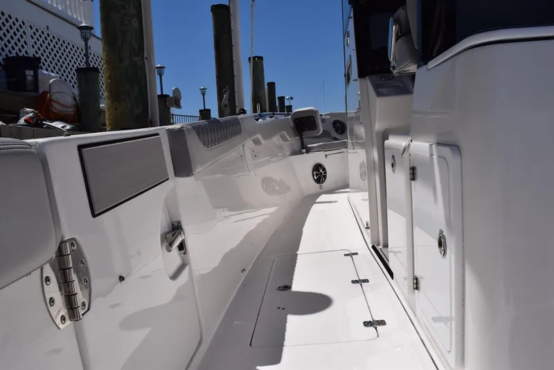 Slide: The Image of 2021 Sea Pro 320 DLX Center Console boat interior, showcasing sleek design and storage compartments. - 25