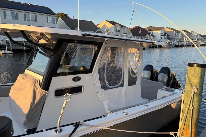 Slide: The Image of 2021 Sea Pro 320 DLX Center Console boat docked in a residential marina. - 3