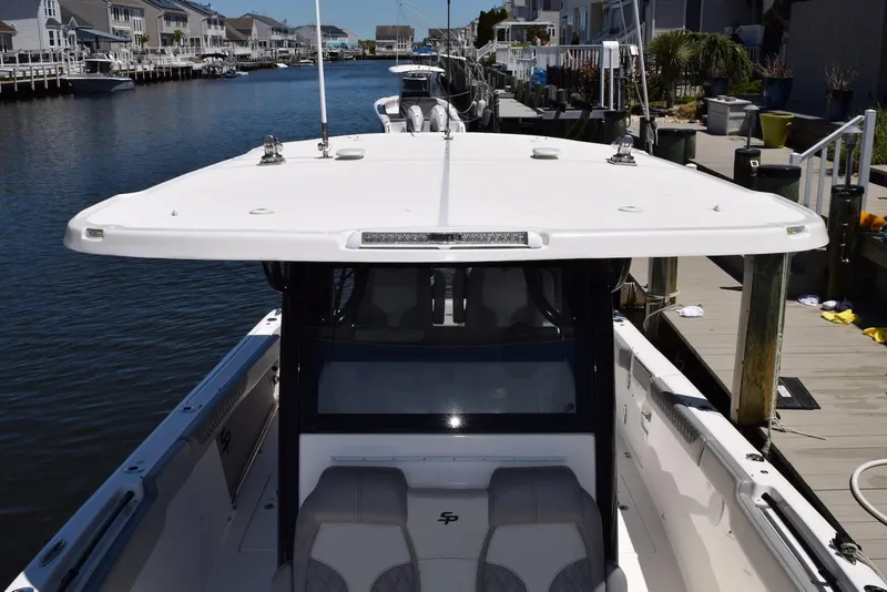 Slide: The Image of 2021 Sea Pro 320 DLX Center Console boat docked in a scenic canal setting. - 31