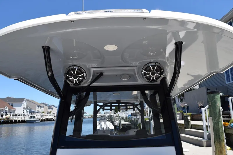 Slide: The Image of 2021 Sea Pro 320 DLX Center Console boat with speakers, docked in a marina. - 33