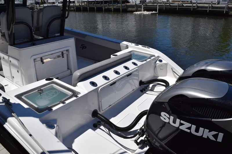 Slide: The Image of 2021 Sea Pro 320 DLX Center Console boat with Suzuki engines docked by the water. - 36