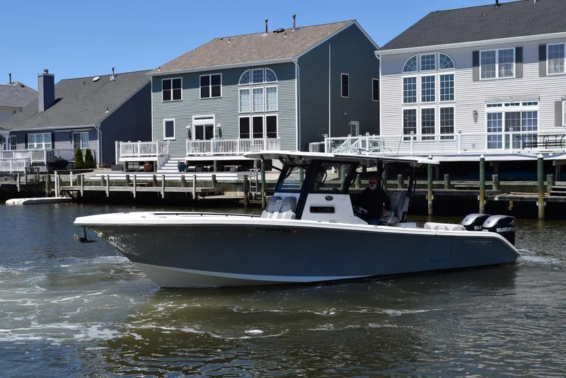 Slide: The Image of 2021 Sea Pro 320 DLX Center Console boat on dry dock under a cloudy sky. - 37