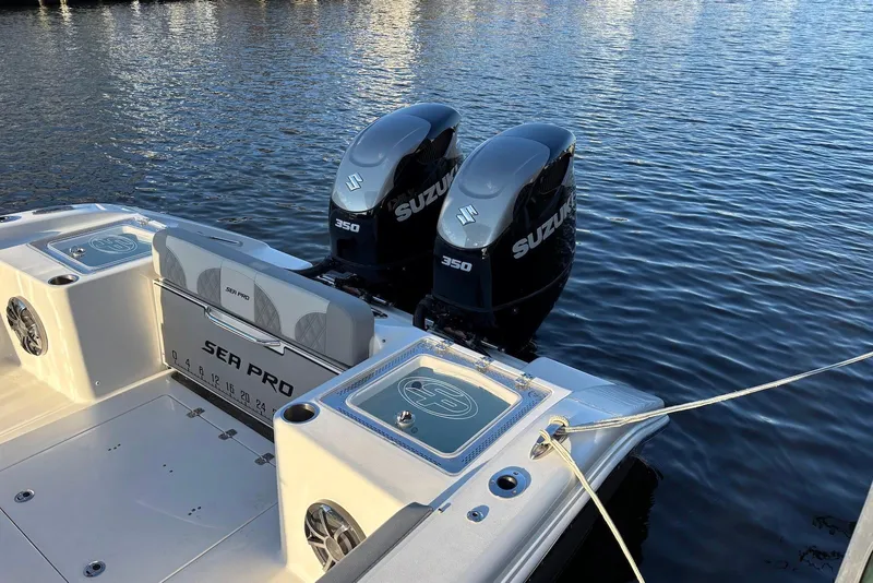 Slide: The Image of 2021 Sea Pro 320 DLX Center Console with dual Suzuki 350 engines on calm water. - 4