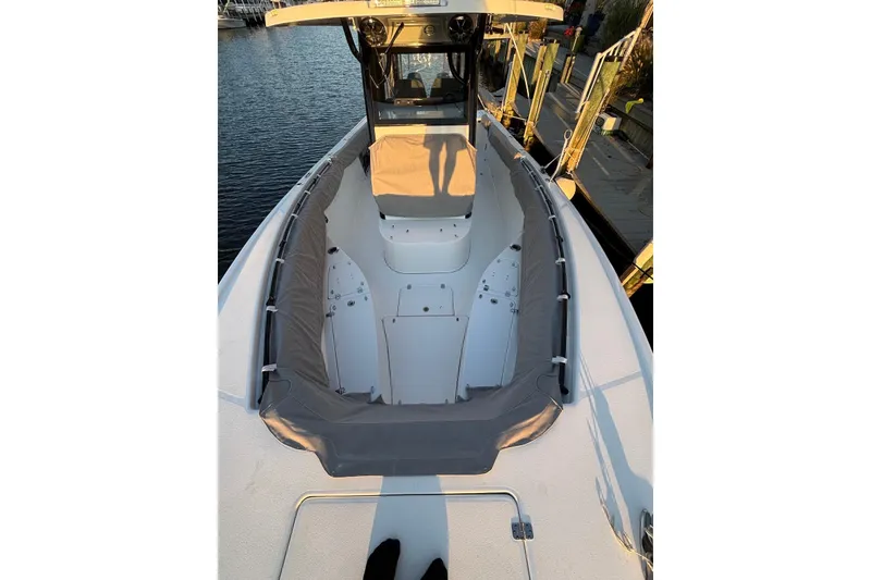 Slide: The Image of 2021 Sea Pro 320 DLX Center Console boat docked, showcasing spacious seating and sleek design. - 7