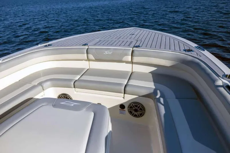Slide: The Image of Manufacturer Provided Image: 2025 Scout 281 XSS boat interior with seating, on calm water. - 6