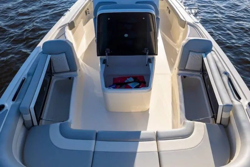 Slide: The Image of Manufacturer Provided Image: 2025 Scout 281 XSS boat interior with seating and storage, on water. - 8