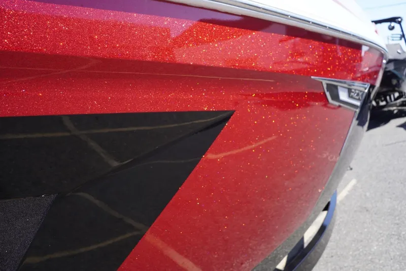 Slide: The Image of 2022 Tigé 22RZX boat with sparkling red and black exterior detailing. - 11