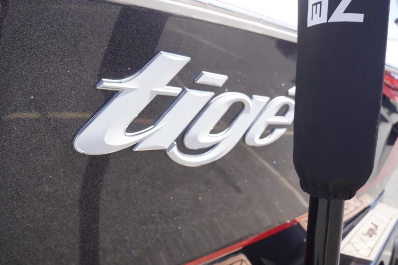 Slide: The Image of 2022 Tigé 22RZX boat logo on sleek black surface. - 13