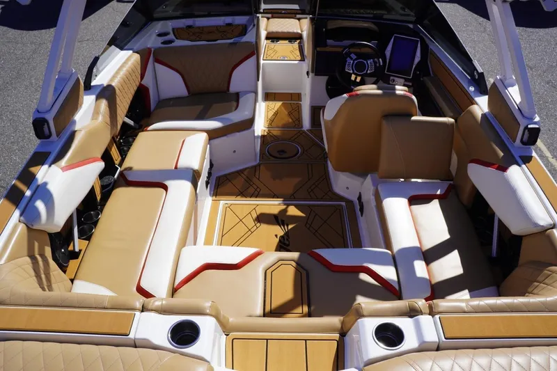 Slide: The Image of 2022 Tigé 22RZX boat interior with luxurious tan and white seating, modern dashboard, and stylish design. - 15