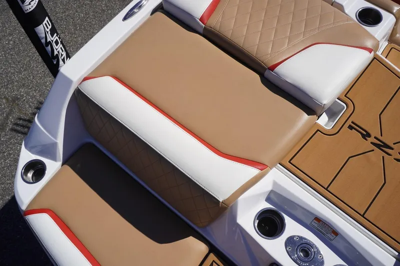 Slide: The Image of 2022 Tigé 22RZX boat interior with tan and white seating, red accents. - 16
