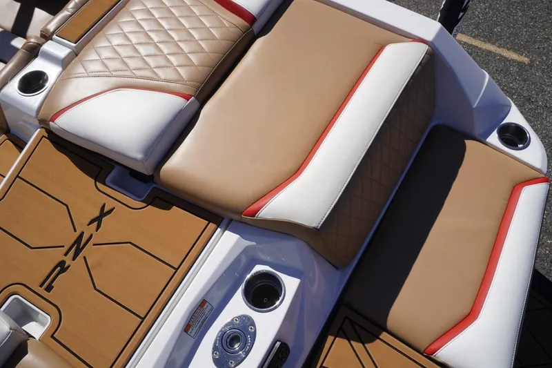 Slide: The Image of 2022 Tigé 22RZX boat interior with tan and white quilted seats. - 17