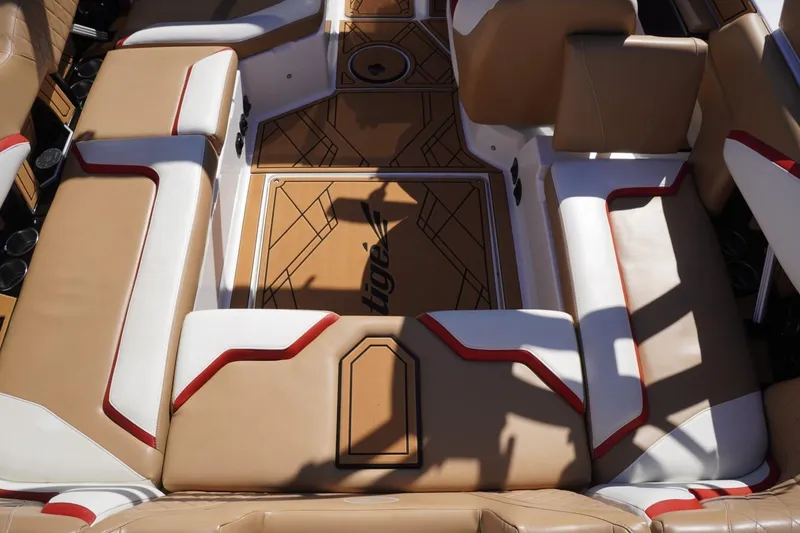 Slide: The Image of 2022 Tigé 22RZX boat interior with tan and white seating, red accents. - 19