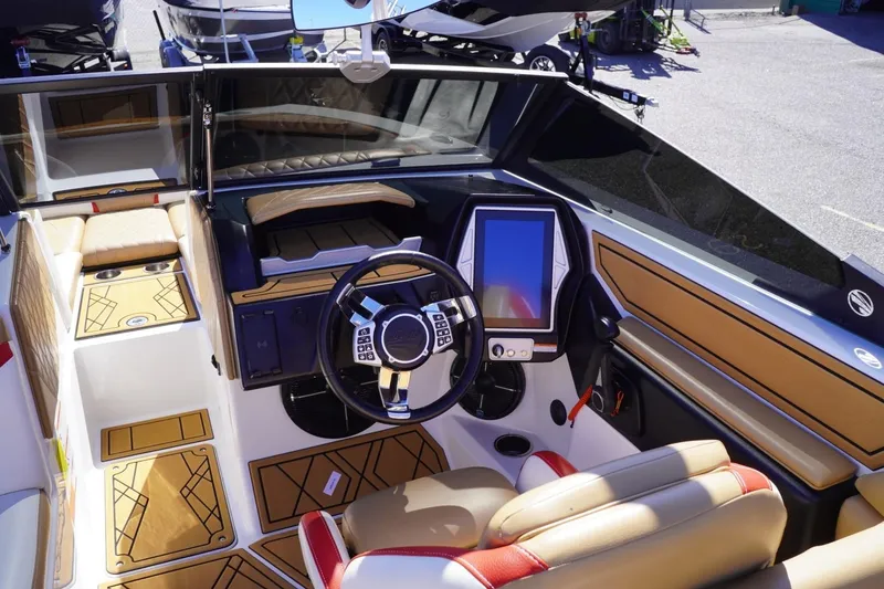 Slide: The Image of 2022 Tigé 22RZX boat interior with modern dashboard and luxurious seating. - 22
