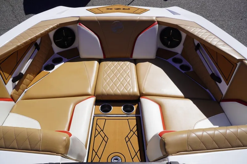 Slide: The Image of Luxurious interior of 2022 Tigé 22RZX boat with tan and white seating. - 23