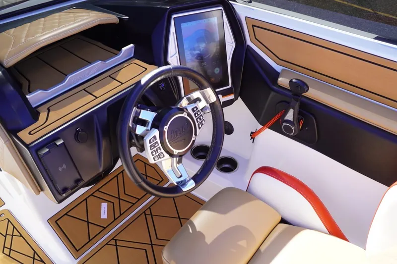 Slide: The Image of 2022 Tigé 22RZX boat interior with modern steering and touchscreen controls. - 29