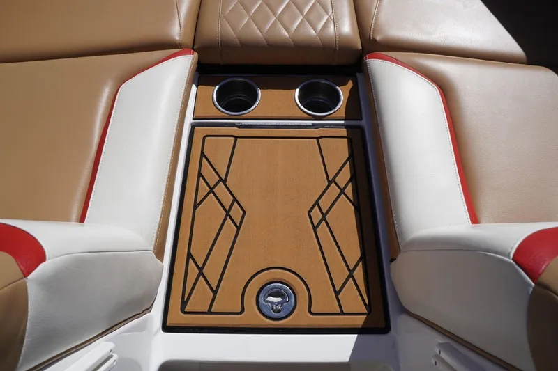 Slide: The Image of 2022 Tigé 22RZX boat interior with tan and white seating, cup holders, and stylish design. - 31