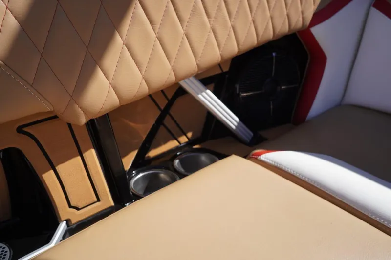 Slide: The Image of Luxurious interior of 2022 Tigé 22RZX boat with tan diamond-stitched upholstery and cup holders. - 39
