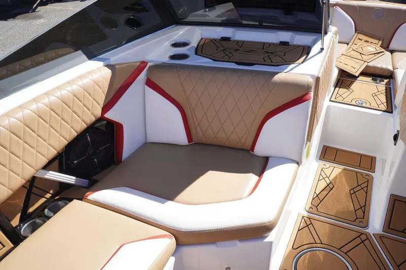 Slide: The Image of 2022 Tigé 22RZX boat interior with tan and white seating, red accents, and custom flooring. - 41