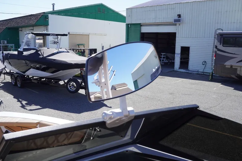 Slide: The Image of 2022 Tigé 22RZX boat with mirror reflection in a marina setting. - 42