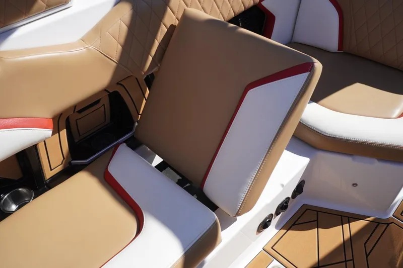 Slide: The Image of 2022 Tigé 22RZX boat interior with tan, white, and red cushioned seating. - 48