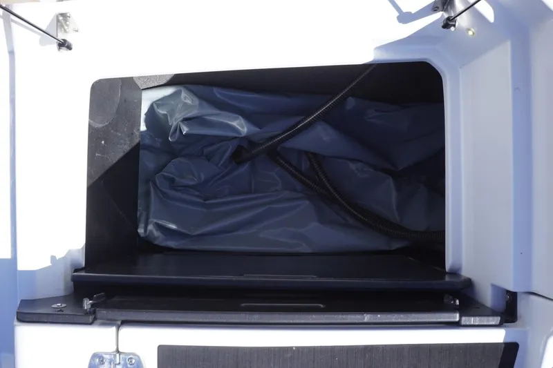 Slide: The Image of Storage compartment of 2022 Tigé 22RZX boat, featuring interior hoses and space. - 51