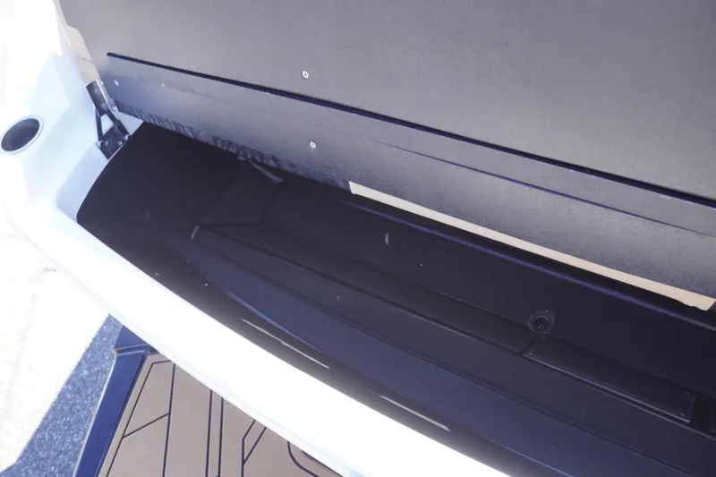 Slide: The Image of 2022 Tigé 22RZX boat storage compartment with open lid, showcasing interior space. - 53