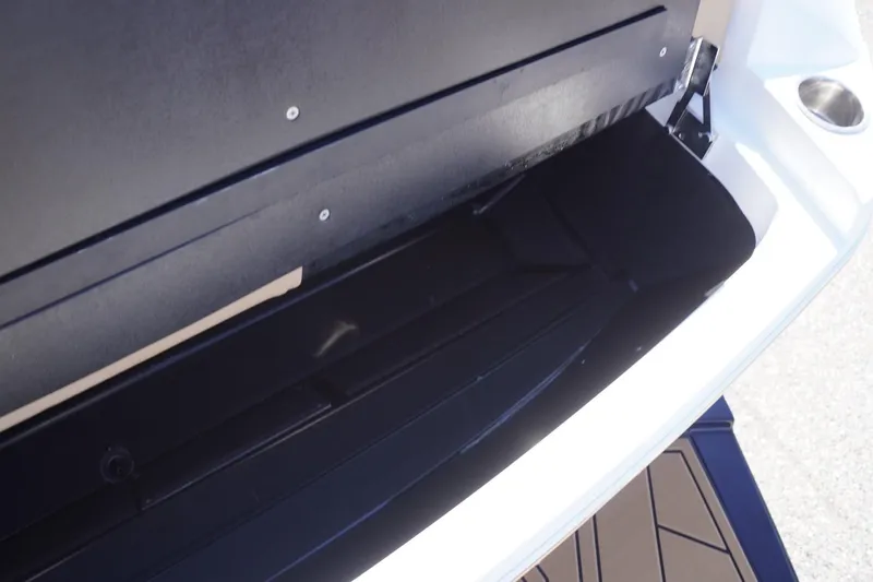 Slide: The Image of Storage compartment of 2022 Tigé 22RZX boat, featuring sleek black interior design. - 54