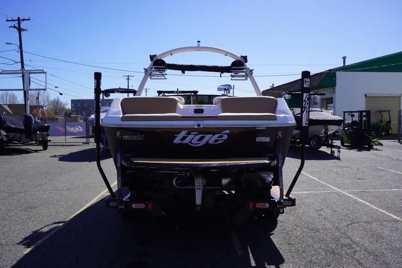 Slide: The Image of 2022 Tigé 22RZX boat parked in a lot, rear view. - 7