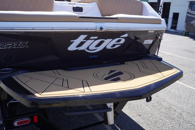 Slide: The Image of 2022 Tigé 22RZX boat rear view with swim platform and logo detailing. - 8