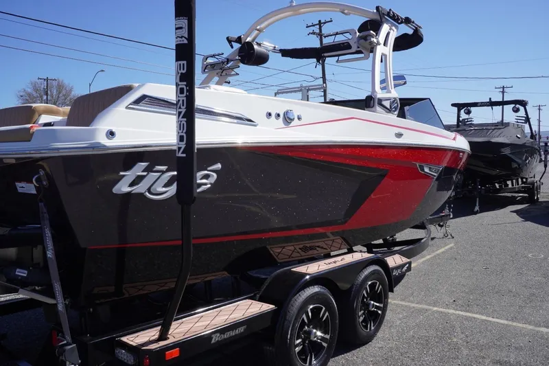 Slide: The Image of 2022 Tigé 22RZX boat with sleek design, red and black color scheme, on a trailer. - 9