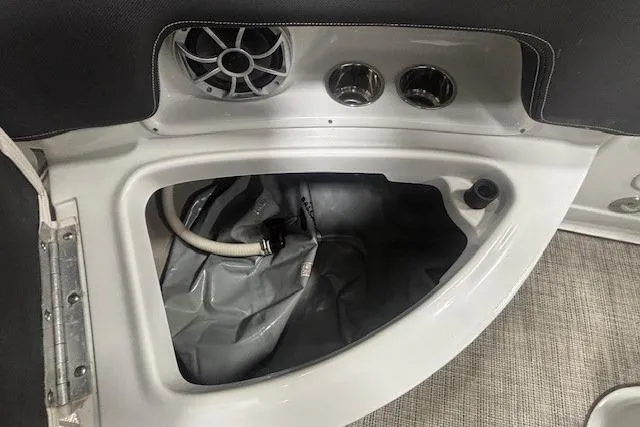 Slide: The Image of 2019 Crownline Eclipse E255 SURF boat interior storage compartment with speaker and cup holders. - 33